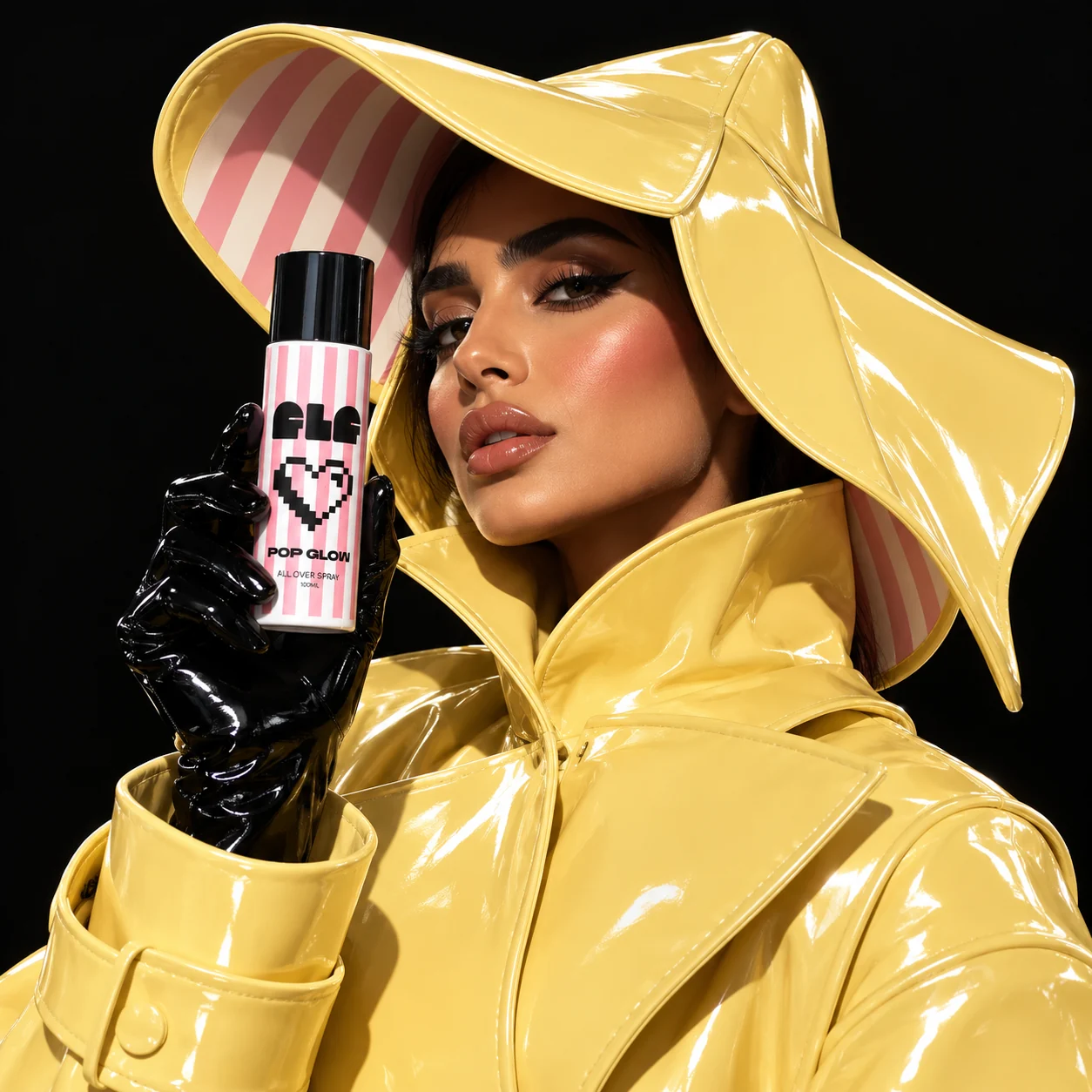 Model in yellow patent hood and trench holding FLF POP GLOW